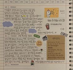 an open notebook with stickers and writing on the pages, containing korean characters in different languages