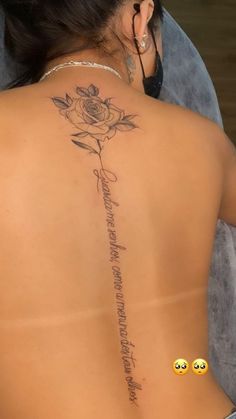 a woman with a rose tattoo on her back