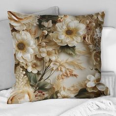 a pillow with flowers on it sitting on a bed