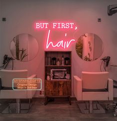 a hair salon with two chairs and a neon sign that says but first, hair