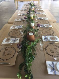 a long table set with place settings and napkins for guests to sit down at