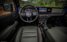 the interior of a vehicle with dashboard, steering wheel and infotains on display