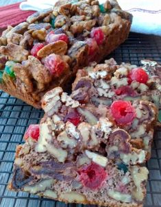 two pieces of fruit and nut bread on a cooling rack