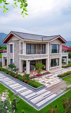 an aerial view of a house in the middle of a lush green field with flowers