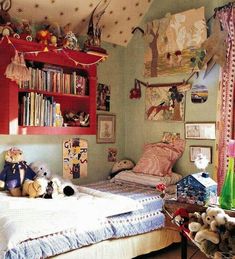 a child's bedroom with stuffed animals and bookshelves on the wall above the bed