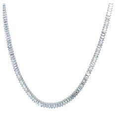 It is crafted in 18 carat white gold. This tennis necklace is set with 4.40 carats of baguette diamonds. It is a timeless piece that will never go out of style. Additional Information: Total Diamond Weight: 4.40ct Diamond Colour: G Diamond Clarity: VS Total Weight: 15.0g Setting Width: 3.36mm Necklace Length: 16""1/2 with adjustable jump ring SMS6950 Luxury Baguette Cut Diamond Tennis Necklace, Luxury Silver Tennis Necklace With Baguette Cut, Luxury Baguette Cut Elegant Tennis Necklace, Diamond White Baguette Cubic Zirconia Tennis Necklace, Fine Jewelry Diamond-cut Tennis Necklace For Formal Occasions, Diamond Tennis Necklace, Tennis Necklace, Baguette Diamond, Diamond Clarity