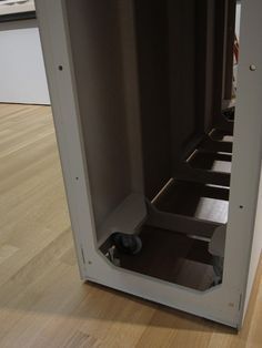 the inside of an empty storage cabinet with wheels