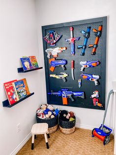 Little Boys Room Wall Shelves, Pegboard Nerf Wall, Fortnight Bedroom Ideas For Boys, Nurf Wall, Nerf Wall Boy Rooms, Nerf Pegboard Wall, Nerf Bedroom Ideas, Nerf Room Ideas Boys, Nerf Wall Storage