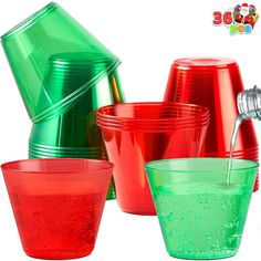 red and green plastic cups are stacked on top of each other, with one being poured into the cup