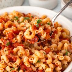 a white bowl filled with pasta and sauce