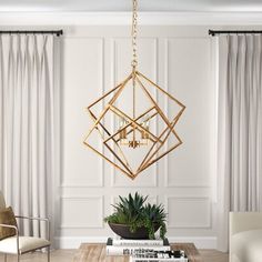 a living room filled with furniture and a gold chandelier hanging from the ceiling