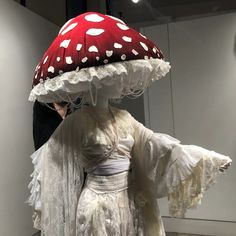 a woman is dressed up as a mushroom