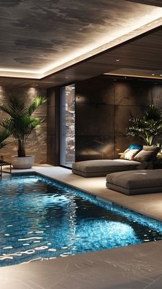 an indoor swimming pool with lounge chairs and potted plants