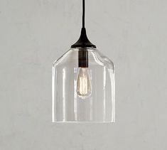 a clear glass light fixture hanging from a ceiling