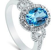 an oval blue topazte and diamond ring on a white background with diamonds around it