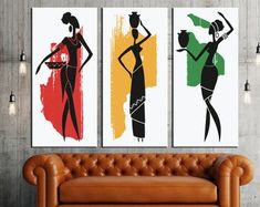 three art prints on the wall above a couch