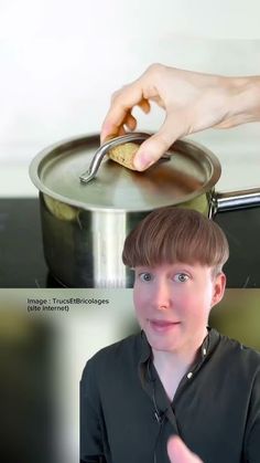 a person holding a spoon in front of a pan with food on top of it