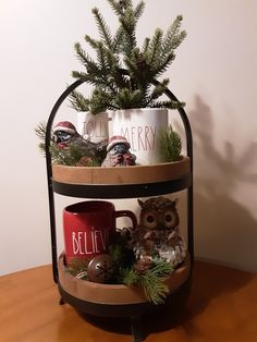 two shelves with coffee mugs and an owl figurine