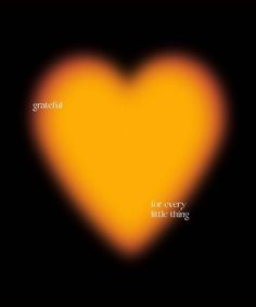 a yellow heart with the words grateful written on it in white lettering, against a black background