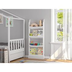 a child's bedroom with a white bed and bookcase