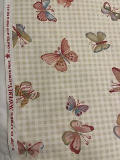 an image of butterflies on a white and pink checkerboard pattern fabric with red accents