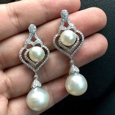 We are presenting you a HUGE pair of CHANDELIER, Genuine, PURE White South Sea Pearls, extremely FINE A+, LUSTROUS and Rare! Accenting the 4 pearls are 136 pieces of E/VS Natural diamonds, weighting a total of 1.62 carats. Set in fabulously designed 18K solid white gold earrings ONLY ONE ITEM AVAILABLE!! NO DUPLICATES!! WHAT YOU SEE IN THE PICTURES IS WHAT YOU WILL GET SOLIDLY HANDCRAFTED EARRINGS! SUGGESTED RETAIL VALUE: $10,880 PEARLS: Size: Bottom Pair 14 x 15 mm, Top Pair 11 mm. Shape: Round Luxury Long Drop Pearl Earrings, Luxury Pearl White Dangle Pearl Earrings, White Pear-shaped Pearl Earrings With Elegant Design, Luxury White Pierced Earrings, Elegant White Pear-shaped Pearl Earrings, Elegant White Teardrop Bridal Earrings, Luxury White Gold Teardrop Pearl Earrings, Luxury Long Drop Pearl Earrings For Wedding, White Sterling Silver Bridal Earrings