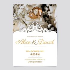 an elegant wedding card with two rings on it and flowers in the background, is shown