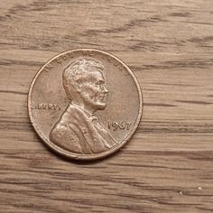 a penny sitting on top of a wooden table