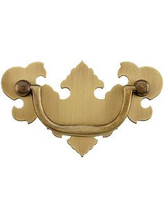 an ornate brass door handle on a white background