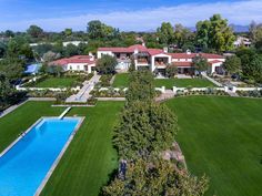 an aerial view of a large house with a pool