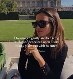 a woman wearing sunglasses sitting on a bench