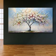 a painting on the wall of a room with wooden flooring and a large tree