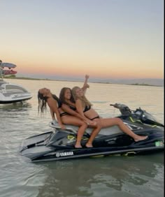 three girls on a jet ski in the water