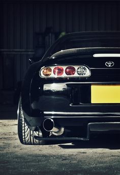 the rear end of a black sports car