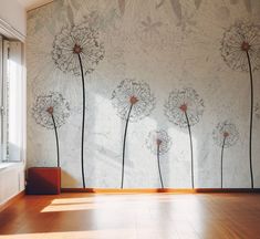 a wall with dandelions painted on it in front of a window and wooden floor