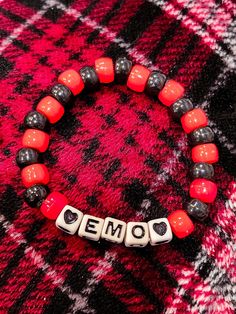 Handmade kandi bracelet that says emo with black hearts! Bracelet is stretchy :) Inner circumference: 6.5 inches Emo Kandi Bracelets, Pony Bead Bracelet Ideas, Matching Kandi Bracelets, Emo Bracelets, Emo Kandi, Scene Bracelets, Bracelets Kandi, Emo Jewelry, Kandi Inspo