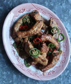 a white plate topped with chicken and peppers