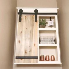 a white shelf with shelves and metal handles on it's sides, hanging from the ceiling