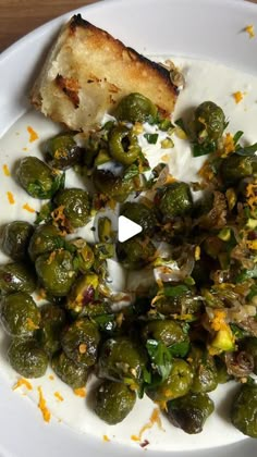 a white plate topped with brussel sprouts and toast