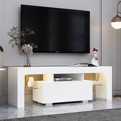 an entertainment center with a large flat screen tv mounted on it's side wall