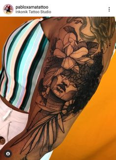 a woman's arm with flowers on it