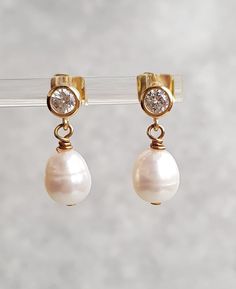 This stunning pair of dangle stud earring. Approximately 8x9mm white freshwater pearls, very good lustre on gold plated stud with cubic zirconia setting.  The earrings is approximately 2cm long The pearls are genuine freshwater pearls therefore each pearl is slightly different in shape, size and each pearl has it own unique natural blemishes The colour of the actual earrings might be slightly different to the photo due to the lighting  All measurement  mentioned in this listing is approximate Mo Pear-shaped Pearl Charm Earrings For Anniversary, Anniversary Bridal Earrings With Pearl Drop In Yellow Gold, Anniversary Yellow Gold Bridal Earrings With Pearl Drop, Anniversary Bridal Earrings In Yellow Gold With Pearl Drop, Anniversary Teardrop Pearl Earrings With High Luster, High Luster Drop Pearl Earrings For Anniversary, Pear-shaped High Luster Pearl Earrings For Wedding, Classic Pearl Drop Dangle Clip-on Earrings, Anniversary Pearl Drop Earrings With Pendant