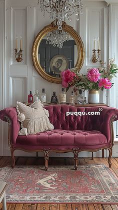 a living room with a couch, chandelier and flowers in vases on the table