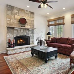 a living room filled with furniture and a fire place