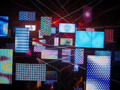 an array of brightly lit squares and rectangles on display in a dark room