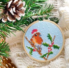 a cross stitch ornament hanging from a christmas tree