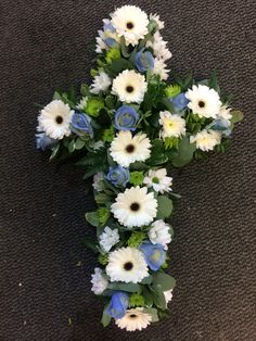 a cross made out of white and blue flowers