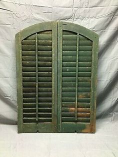 an old green shuttered window on a white background