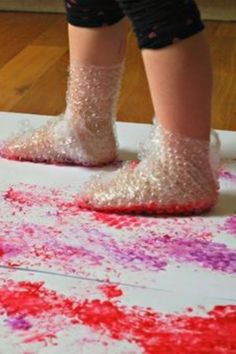 a child's feet in glitter covered shoes on top of a piece of paper