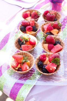 small bowls filled with fruit sitting on top of a table